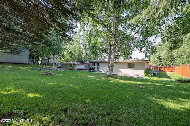 14121 Sunview Dr, Anchorage, AK 99515 - fenced backyard featuring a fire pit