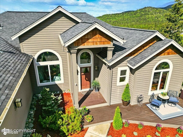 16071 Mountain Air Dr, Anchorage, AK 99516 - view of front of property featuring a shingled roof and a deck with mountain view