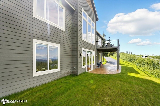 16071 Mountain Air Dr, Anchorage, AK 99516 - view of side of home with a patio area, a yard, and a wooden deck