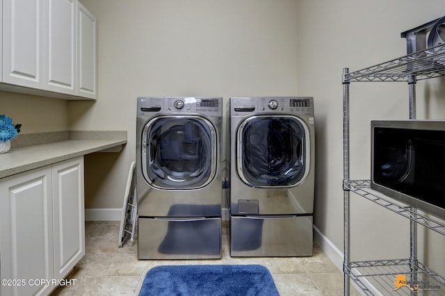 16071 Mountain Air Dr, Anchorage, AK 99516 - laundry room with washing machine and clothes dryer and cabinet space