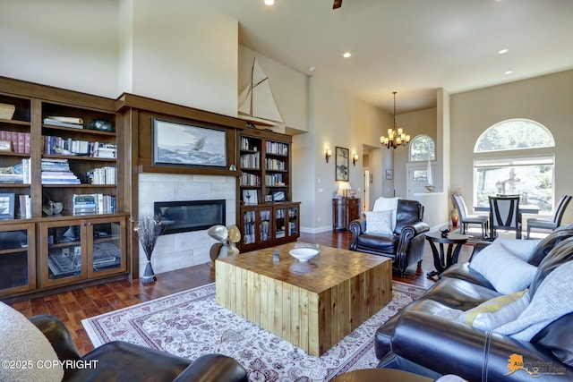 16071 Mountain Air Dr, Anchorage, AK 99516 - living room with a high ceiling, a fireplace, a chandelier, wood finished floors, and recessed lighting