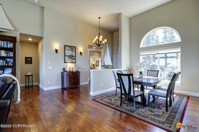 16071 Mountain Air Dr, Anchorage, AK 99516 - dining space with a towering ceiling, a chandelier, and wood finished floors