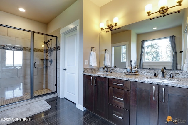 16071 Mountain Air Dr, Anchorage, AK 99516 - full bath with a stall shower, double vanity, healthy amount of natural light, recessed lighting, and wood finished floors