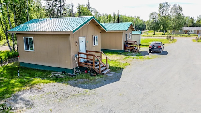 46210 Bonita Ave, Soldotna, AK 99669 - view of front of property featuring a metal roof, view of scattered trees, and driveway