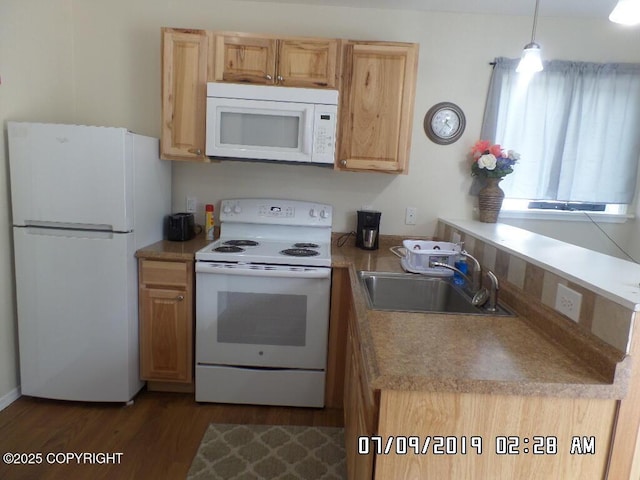46210 Bonita Ave, Soldotna, AK 99669 - kitchen featuring white appliances, dark wood-style flooring, a peninsula, and light countertops
