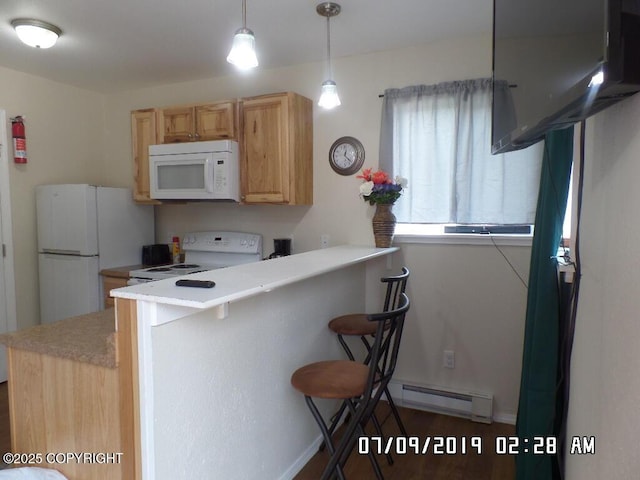 46210 Bonita Ave, Soldotna, AK 99669 - kitchen featuring white appliances, a breakfast bar, a peninsula, light countertops, and hanging light fixtures