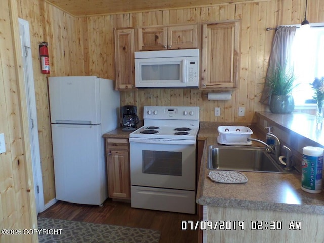 46210 Bonita Ave, Soldotna, AK 99669 - kitchen featuring white appliances, wood walls, and dark wood finished floors