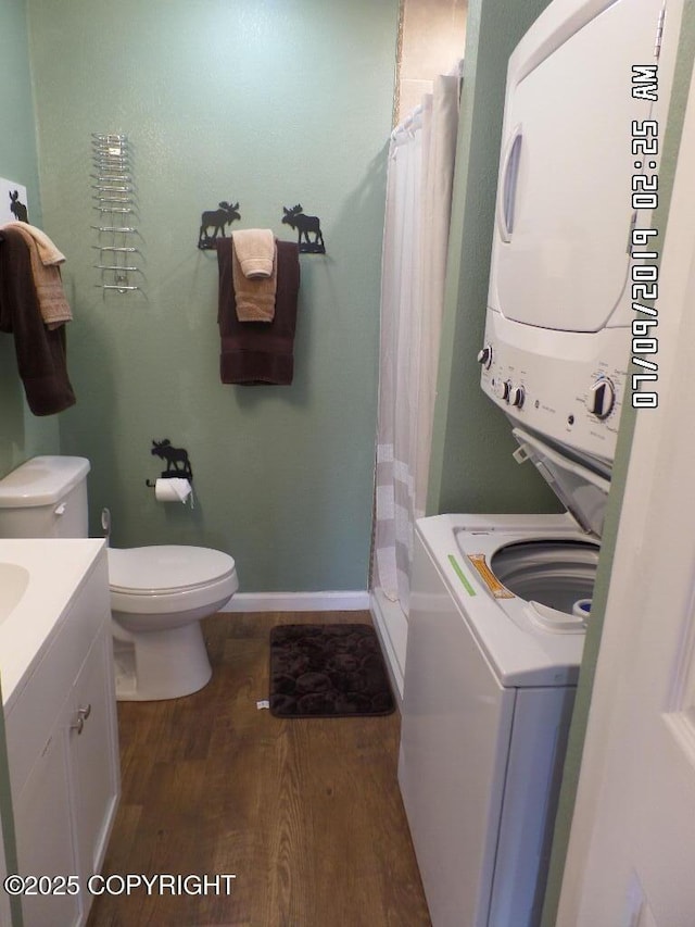46210 Bonita Ave, Soldotna, AK 99669 - laundry room featuring stacked washer / dryer and dark wood-type flooring