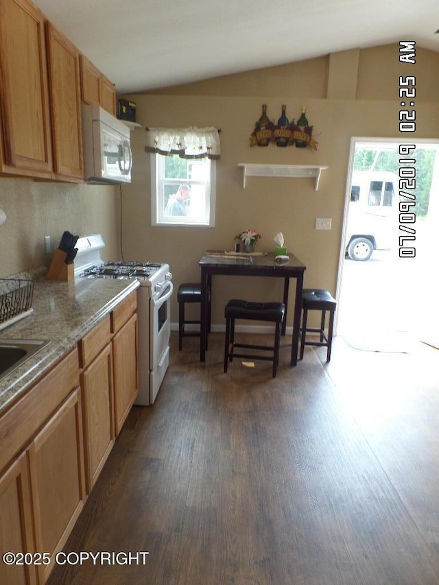 46210 Bonita Ave, Soldotna, AK 99669 - kitchen with white appliances, healthy amount of natural light, dark wood-style flooring, and lofted ceiling