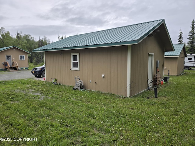46210 Bonita Ave, Soldotna, AK 99669 - view of home's exterior with a metal roof and a lawn