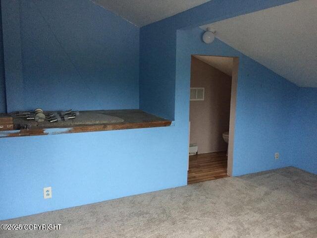 53245 Coyote Ln, Nikiski/North Kenai, AK 99611 - bonus room with carpet flooring and vaulted ceiling