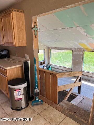 53245 Coyote Ln, Nikiski/North Kenai, AK 99611 - kitchen featuring plenty of natural light, light tile patterned floors, and light countertops