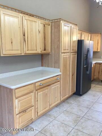 53245 Coyote Ln, Nikiski/North Kenai, AK 99611 - kitchen with refrigerator with ice dispenser, light countertops, light brown cabinets, and light tile patterned floors