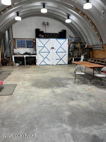 53245 Coyote Ln, Nikiski/North Kenai, AK 99611 - miscellaneous room with concrete flooring and a workshop area