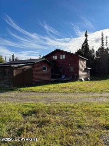 53245 Coyote Ln, Nikiski/North Kenai, AK 99611 - view of side of property with a lawn