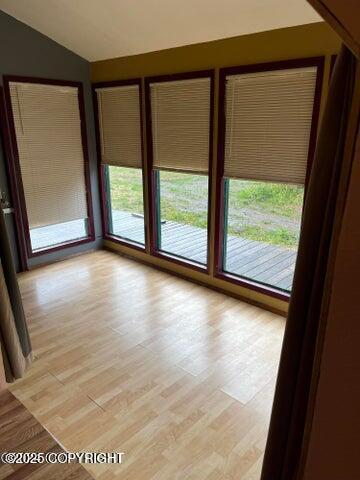 53245 Coyote Ln, Nikiski/North Kenai, AK 99611 - unfurnished room with lofted ceiling and light wood-type flooring