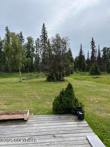 53245 Coyote Ln, Nikiski/North Kenai, AK 99611 - view of green lawn with a wooden deck