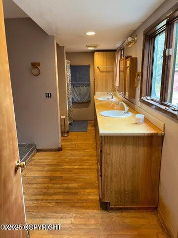 53245 Coyote Ln, Nikiski/North Kenai, AK 99611 - full bath with wood finished floors, double vanity, and recessed lighting