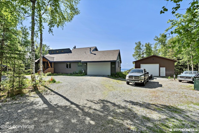 19712 Chugach Park Dr, Eagle River, AK 99567 - view of side of home featuring a garage and a shingled roof
