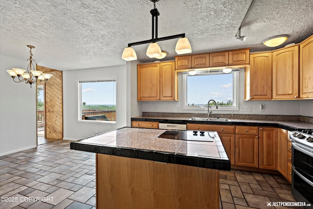 19712 Chugach Park Dr, Eagle River, AK 99567 - kitchen featuring a chandelier, healthy amount of natural light, double oven range, black electric cooktop, and a textured ceiling