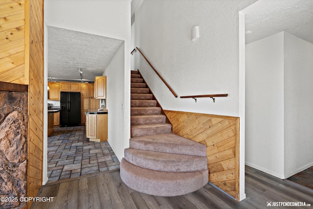 19712 Chugach Park Dr, Eagle River, AK 99567 - staircase with a textured ceiling and wood finished floors