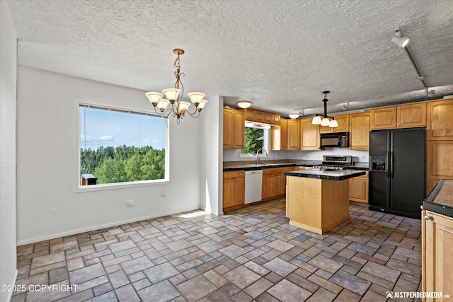 19712 Chugach Park Dr, Eagle River, AK 99567 - kitchen featuring black appliances, a chandelier, dark countertops, a center island, and a textured ceiling
