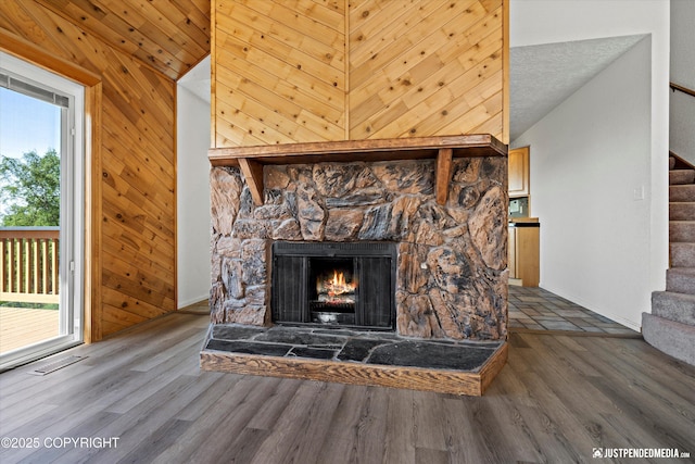 19712 Chugach Park Dr, Eagle River, AK 99567 - detailed view of wood finished floors, a stone fireplace, and wood walls