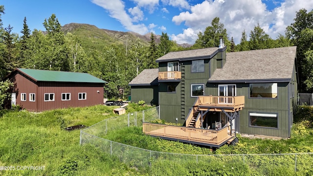 19712 Chugach Park Dr, Eagle River, AK 99567 - rear view of property featuring a fenced backyard, a deck with mountain view, stairs, a balcony, and roof with shingles