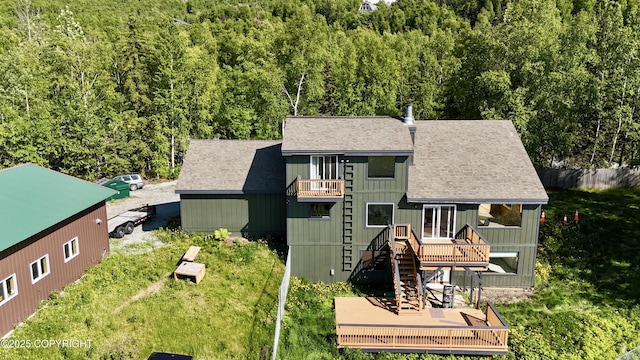 19712 Chugach Park Dr, Eagle River, AK 99567 - rear view of house with a balcony, a wooden deck, a shingled roof, a wooded view, and stairs