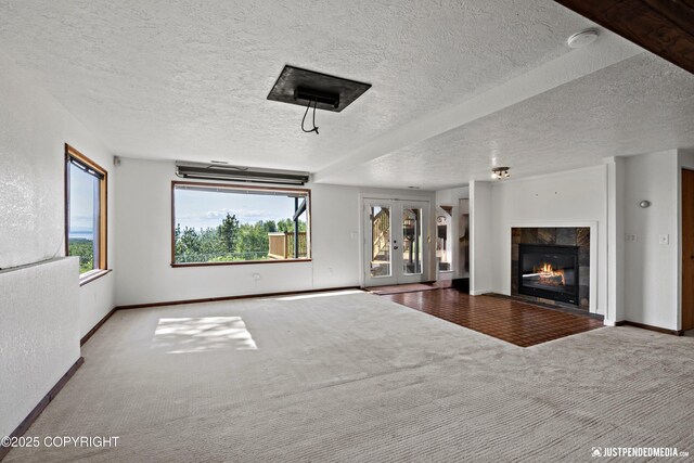 19712 Chugach Park Dr, Eagle River, AK 99567 - unfurnished living room with carpet, a fireplace, a textured ceiling, and french doors