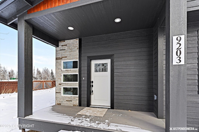 9203 Strutz Ave, Anchorage, AK 99507 - snow covered property entrance featuring stone siding