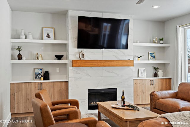 9203 Strutz Ave, Anchorage, AK 99507 - living room featuring wood finished floors, built in features, and a high end fireplace