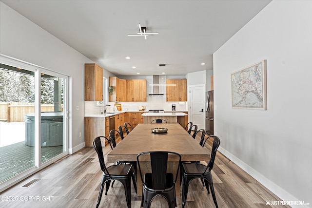 9203 Strutz Ave, Anchorage, AK 99507 - dining room with light wood-style floors and recessed lighting