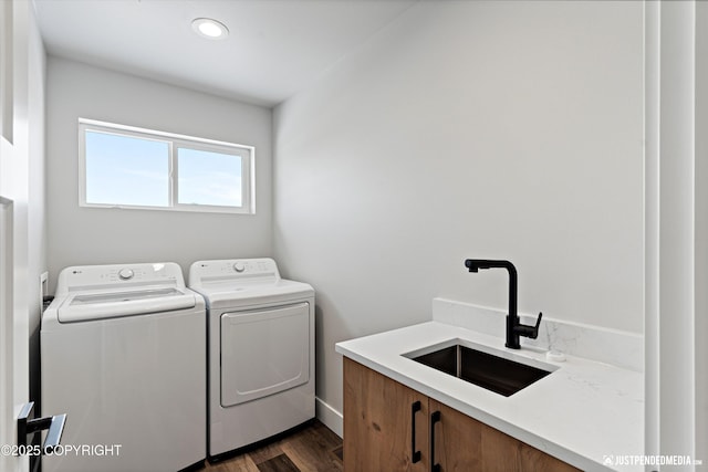 9203 Strutz Ave, Anchorage, AK 99507 - washroom featuring washer and dryer, dark wood finished floors, and cabinet space