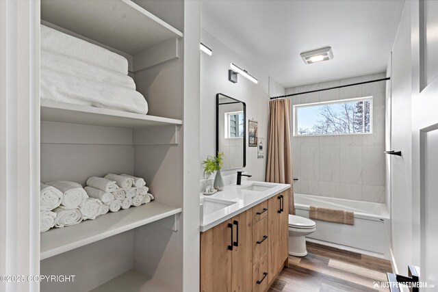 9203 Strutz Ave, Anchorage, AK 99507 - bathroom featuring double vanity, wood finished floors, and shower / tub combo with curtain