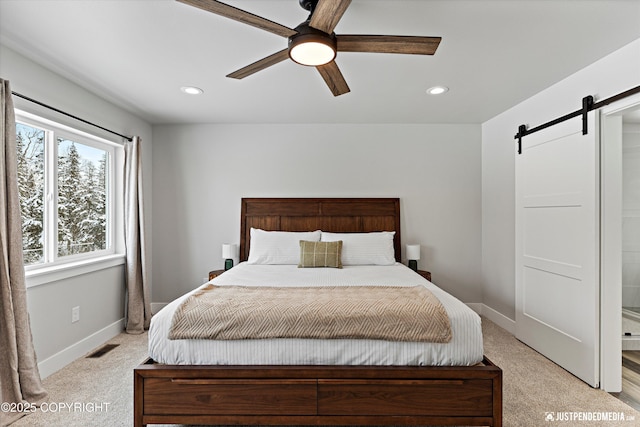 9203 Strutz Ave, Anchorage, AK 99507 - bedroom with a barn door, light colored carpet, recessed lighting, and a ceiling fan