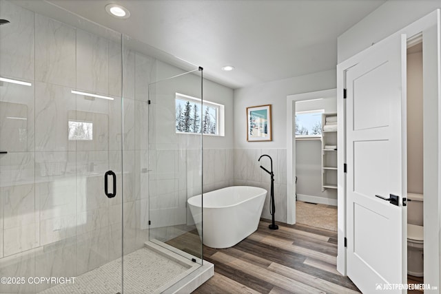 9203 Strutz Ave, Anchorage, AK 99507 - full bath with a freestanding bath, a stall shower, recessed lighting, wood finished floors, and tile walls