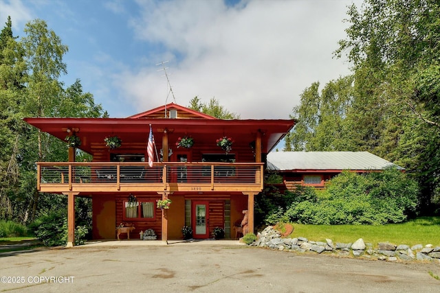 3890 Janet Lee Cir, Anchorage, AK 99516 - view of front of property featuring driveway, log veneer siding, and a wooden deck