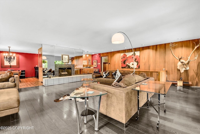 3890 Janet Lee Cir, Anchorage, AK 99516 - living area featuring wooden walls, wood finished floors, a fireplace, and a chandelier