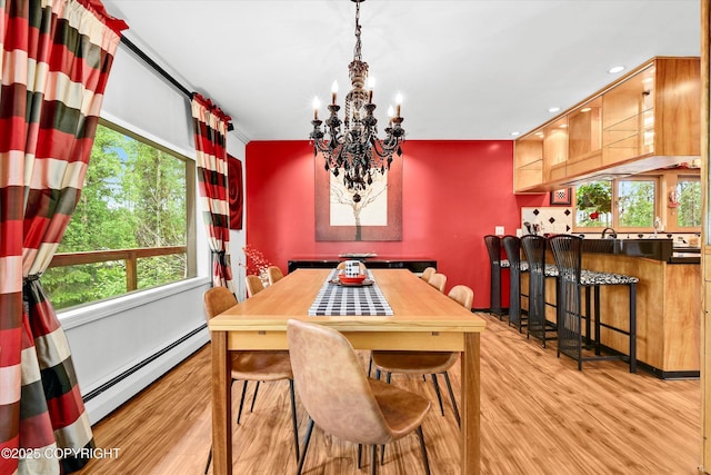 3890 Janet Lee Cir, Anchorage, AK 99516 - dining space featuring a baseboard radiator, light wood finished floors, a chandelier, plenty of natural light, and recessed lighting