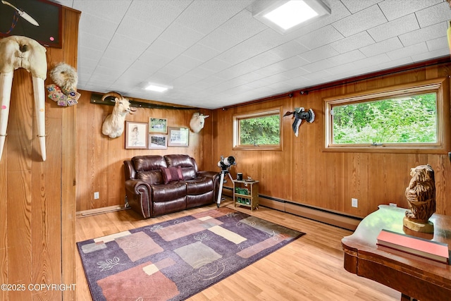 3890 Janet Lee Cir, Anchorage, AK 99516 - living room featuring wood finished floors, a baseboard radiator, and wood walls