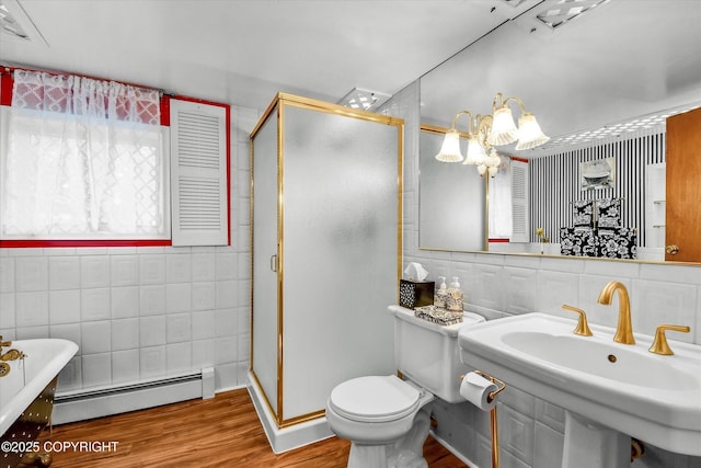 3890 Janet Lee Cir, Anchorage, AK 99516 - full bathroom featuring a baseboard heating unit, tile walls, a soaking tub, a stall shower, and wood finished floors