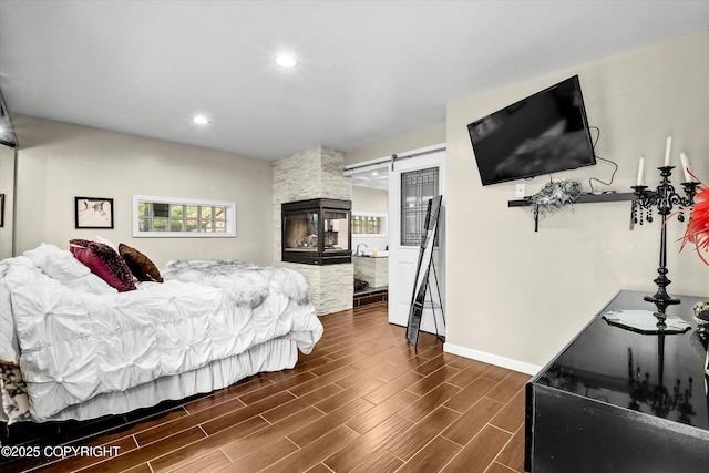 3890 Janet Lee Cir, Anchorage, AK 99516 - bedroom with a barn door, dark wood-style flooring, and recessed lighting