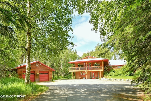 3890 Janet Lee Cir, Anchorage, AK 99516 - view of front of house with an outbuilding, asphalt driveway, a detached garage, and log exterior