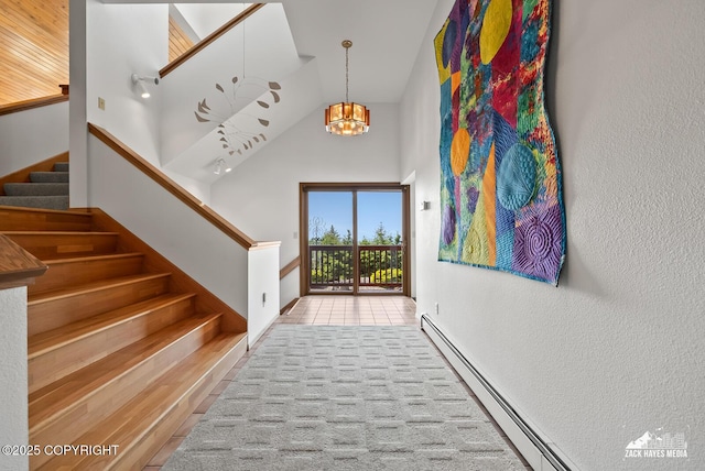 11411 Snowline Dr, Anchorage, AK 99507 - stairway featuring a chandelier, baseboard heating, high vaulted ceiling, and a textured wall