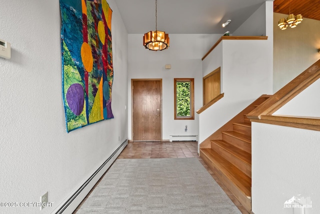 11411 Snowline Dr, Anchorage, AK 99507 - tiled entryway featuring a chandelier, baseboard heating, stairway, and a towering ceiling