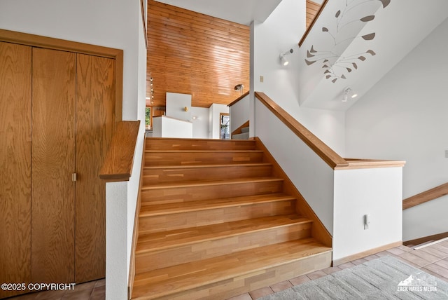 11411 Snowline Dr, Anchorage, AK 99507 - stairway with tile patterned floors and high vaulted ceiling