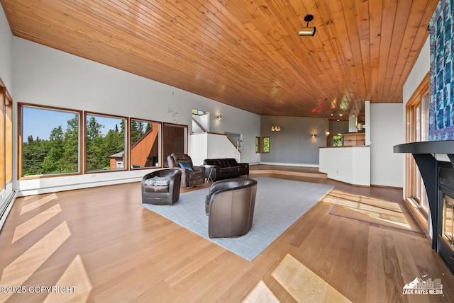 11411 Snowline Dr, Anchorage, AK 99507 - living room with wood ceiling, healthy amount of natural light, wood finished floors, a glass covered fireplace, and stairs