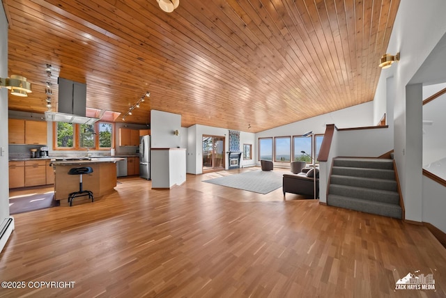11411 Snowline Dr, Anchorage, AK 99507 - unfurnished living room with wood ceiling, lofted ceiling, stairs, light wood finished floors, and rail lighting