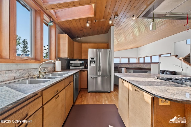 11411 Snowline Dr, Anchorage, AK 99507 - kitchen with appliances with stainless steel finishes, light wood-type flooring, a skylight, lofted ceiling, and open floor plan